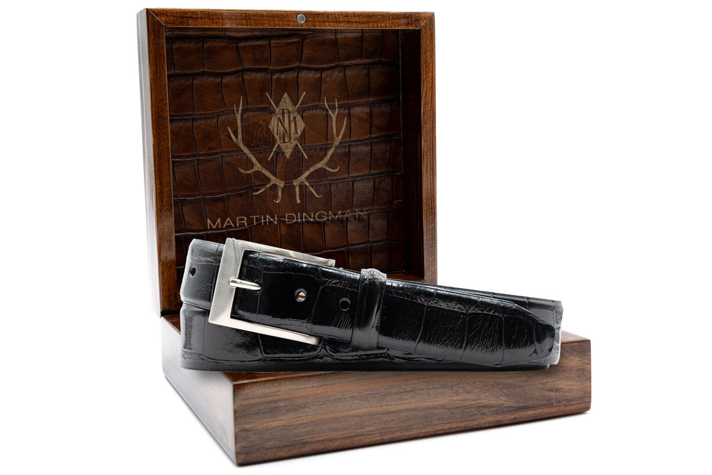 Hand Glazed Genuine American Alligator Belt - Black in front of open Martin Dingman Solid Wood Display Box lined with Alligator Grain Leather.