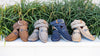 4 Bermuda Braid Nubuck Belts draped over the same shade of Bermuda Nubuck Horse Bit Loafers in the shades: bark, navy, sand, slate.