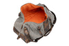 Back Side View of Woodland Quilted Oxford Canvas Duffel - Stone with Camo Saddle Leather Trim with Clamshell Zipper Open featuring Signature Orange Cotton Twill Lining