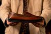 man holding Bermuda Saddle Leather Penny Loafers - Whiskey